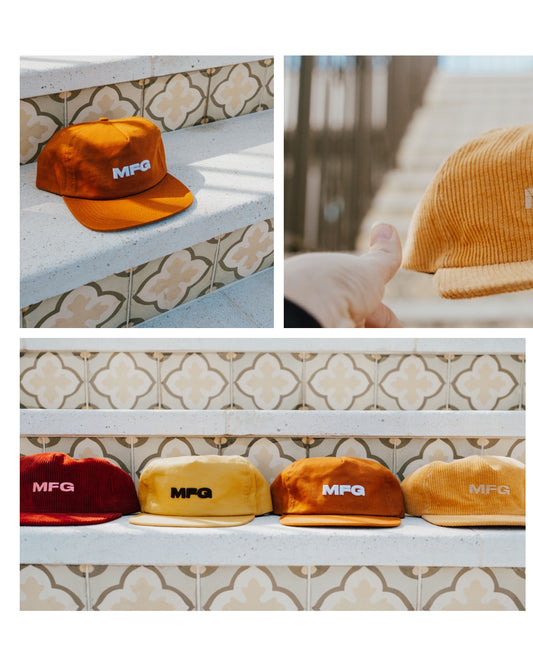 A variety of MFG branded 5 panel hats on a tile step. Merlot and other colors shown
